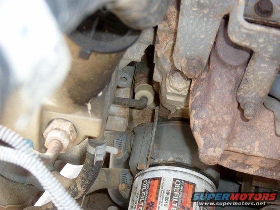 s3500505.jpg Here you can see the stock "dumby" sender above the oil filter to the left, with the wire going to the left (it is tan in color)  The sender was not fun to remove, it was supposed to be sized for a 1" wrench, but was not.  I ended up getting it off with a poor man's socket wrench (vise grips.)