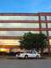 2000 Ford Crown Victoria - A white 2000 Ford Crown Victoria is parked outside an office building during sunset.