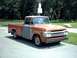 1954 Ford F-100 - This 1959 Ford F-series truck shows primer on its driver's side, contrasting with its red bed.