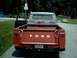 1954 Ford F-100 - This Ford pickup truck has a red body and a gray cab. The tailgate is down, showing the Ford lettering.
