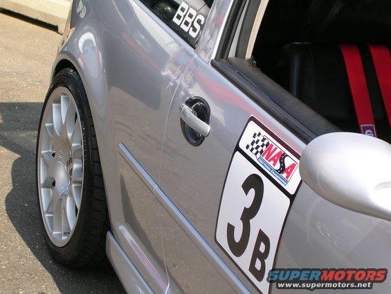 Silver car side view with racing number 3B and NASA decal