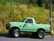 1990 Ford Bronco - Side view of a green 1990 Ford Bronco with large tires.