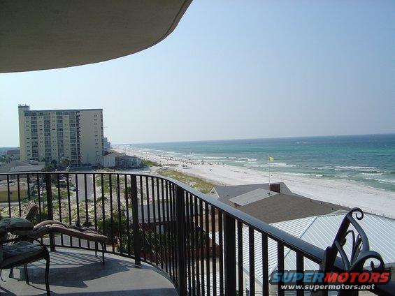 Balcony view of a beach with buildings and ocean