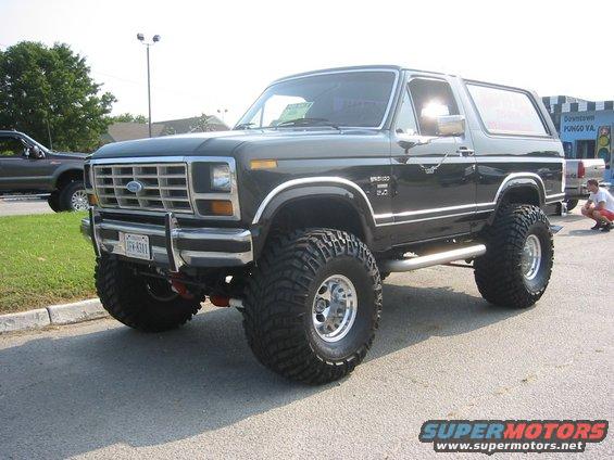 Black lifted 1980s Ford Bronco with chrome trim and large tires