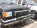 1988 Ford Bronco - Front view of a black Ford Bronco parked next to a white Ford pickup truck.
