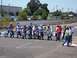 1990 Ford Bronco - Mini bikes and riders line up at the start of a race on a paved track.