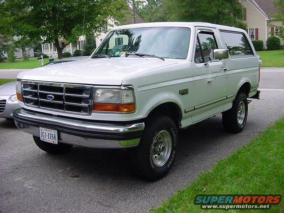 1989 Ford Bronco parked on driveway, front 3/4 view. License plate reads JGI-1768
