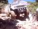 1976 Ford F-100 - This modified vehicle navigates a challenging rocky terrain under a clear blue sky.