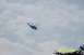 1979 Ford Bronco II - A helicopter is seen flying in the sky, silhouetted against the clouds.