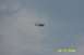 1979 Ford Bronco II - A helicopter is seen in flight against a cloudy sky.
