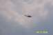 1979 Ford Bronco II - A helicopter is seen flying in a cloudy sky. The image has a watermark at the bottom right.