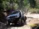 1976 Ford F-100 - Modified pickup truck with large tires navigating a rocky off-road trail.