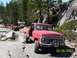 1976 Ford F-100 - A red 1976 Ford F-100 navigates a rocky trail, with other off-road vehicles visible in the background.
