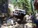 1976 Ford F-100 - Off-road truck navigates a rocky trail with steep inclines and large boulders.