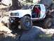 1976 Ford F-100 - A modified pickup truck navigates a rocky off-road course.