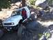 1976 Ford F-100 - A white off-road vehicle tackles a rocky trail, with a date stamp indicating March 11, 2003.
