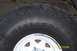 1996 Ford Bronco - A close-up view of a vehicle's tire and wheel assembly, showing tread detail and markings.