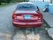 2000 Ford Taurus - Rear view of a red 2000 Ford Taurus parked outdoors.