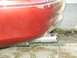 2000 Ford Taurus - A close-up view of the rear of a red vehicle, focusing on the bumper and exhaust pipe.