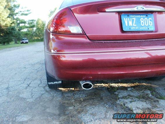 Red 2000 Ford Taurus rear bumper with license plate VWZ 806 and exhaust pipe
