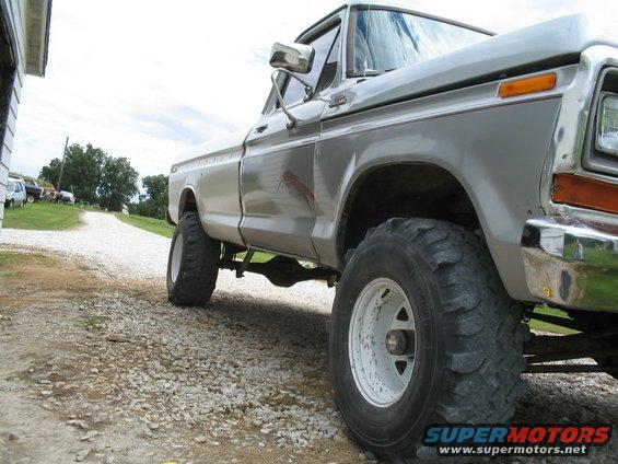 Silver 1979 Ford F-150 lifted with large tires, viewed from the side