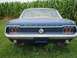 1967 Ford Mustang - Rear view of a blue 1967 Ford Mustang, showing its distinctive triple taillights and 'Mustang' badging.