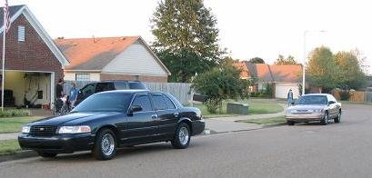 1995 Ford Crown Victoria parked on street, another sedan in background