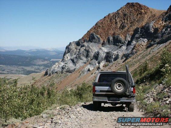 Rear view of a gray 1996 Ford Bronco on a mountain road