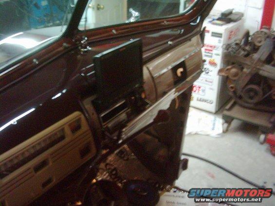 picture-142.jpg A shot of the dash my dad restored and painted.  You can see the DVD player inside the radio grille.  The grille motorizes down and the DVD screen motorizes out and up.