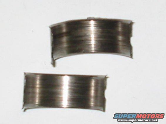 two worn engine bearings