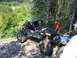 1990 Ford Bronco - An off-road buggy navigates a challenging rocky trail with spectators nearby.