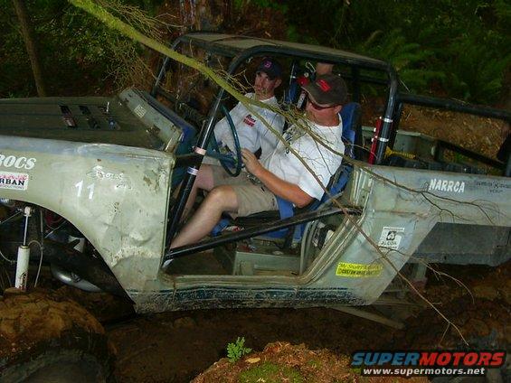 Off-road vehicle interior with two occupants, mud terrain