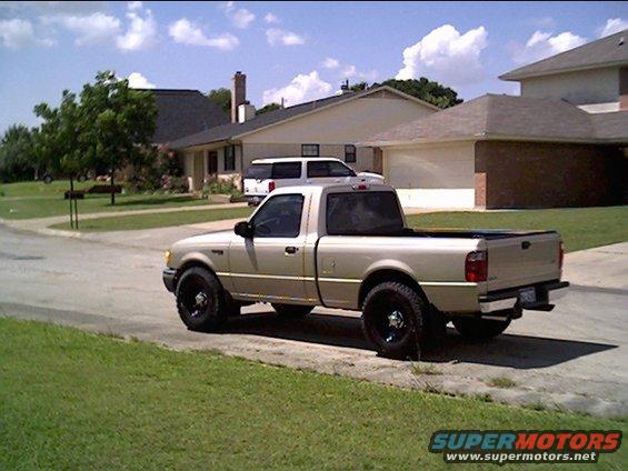 Gold 2002 Ford Ranger pickup truck parked on a residential street