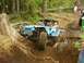 1990 Ford Bronco - A modified off-road buggy tackles a challenging dirt course in a wooded area.