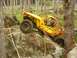1990 Ford Bronco - This custom-built buggy navigates a challenging rocky terrain in a wooded area.