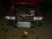 1990 Ford Bronco - Front end of a red vehicle with the hood open, showing the engine bay and an installed intercooler, with various tools on the ground.