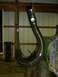 1990 Ford Bronco - Custom exhaust pipe with yellow accent stripes, suspended in a workshop.