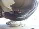 1990 Ford Bronco - Underside view of a vehicle's exhaust system, with a person's shoes visible beneath.