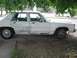 1988 Ford Crown Victoria - This 1988 Ford Crown Victoria shows signs of wear and tear, with visible rust and bodywork imperfections.