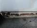 1988 Ford Crown Victoria - The lower body panel of a white vehicle shows significant corrosion and damage.