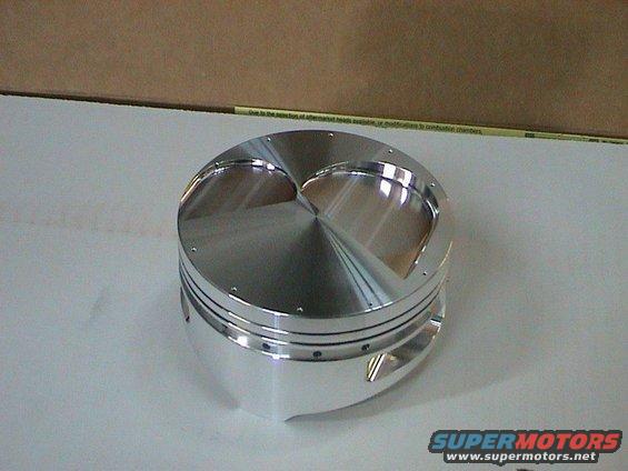 Polished aluminum engine piston with three valve reliefs on top