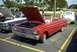 1967 Ford LTD - Red 1963 Ford Falcon convertible at a car show, hood up, parked next to another classic car.