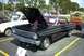 1967 Ford LTD - A black 1963 Ford Falcon is displayed with its hood open at an outdoor car show.