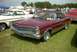 1967 Ford LTD - A maroon 1967 Ford LTD convertible with a black top is displayed at an outdoor event, with other vehicles and tents in the background.
