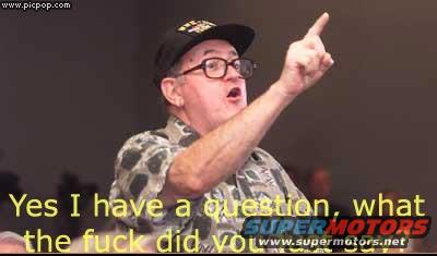 Man in a cap and glasses points upwards while speaking, with text overlay