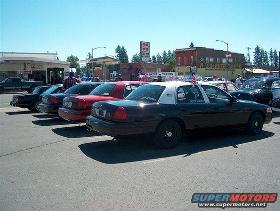 2001 Ford Crown Victoria police car parked next to other vehicles