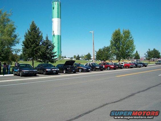 Black police car parked in a line of vehicles