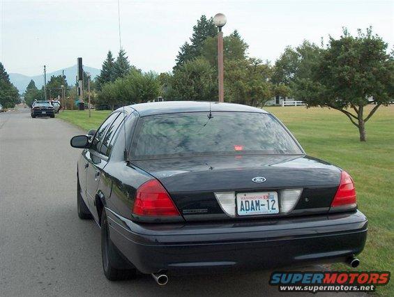 Rear view of a black 2001 Ford Crown Victoria with Washington plates