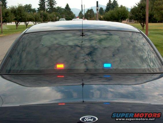 2001 Ford Crown Victoria rear, showing blue and red interior police lights and Ford badge