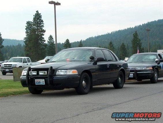2001 Ford Crown Victoria police car with push bar and "ADAM-12" license plate